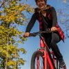 happy woman riding red bike