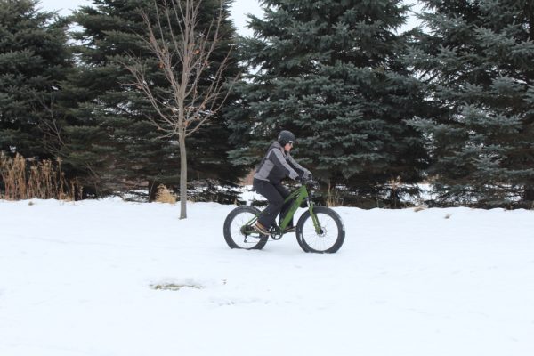 Female Riding Bike In Snow
